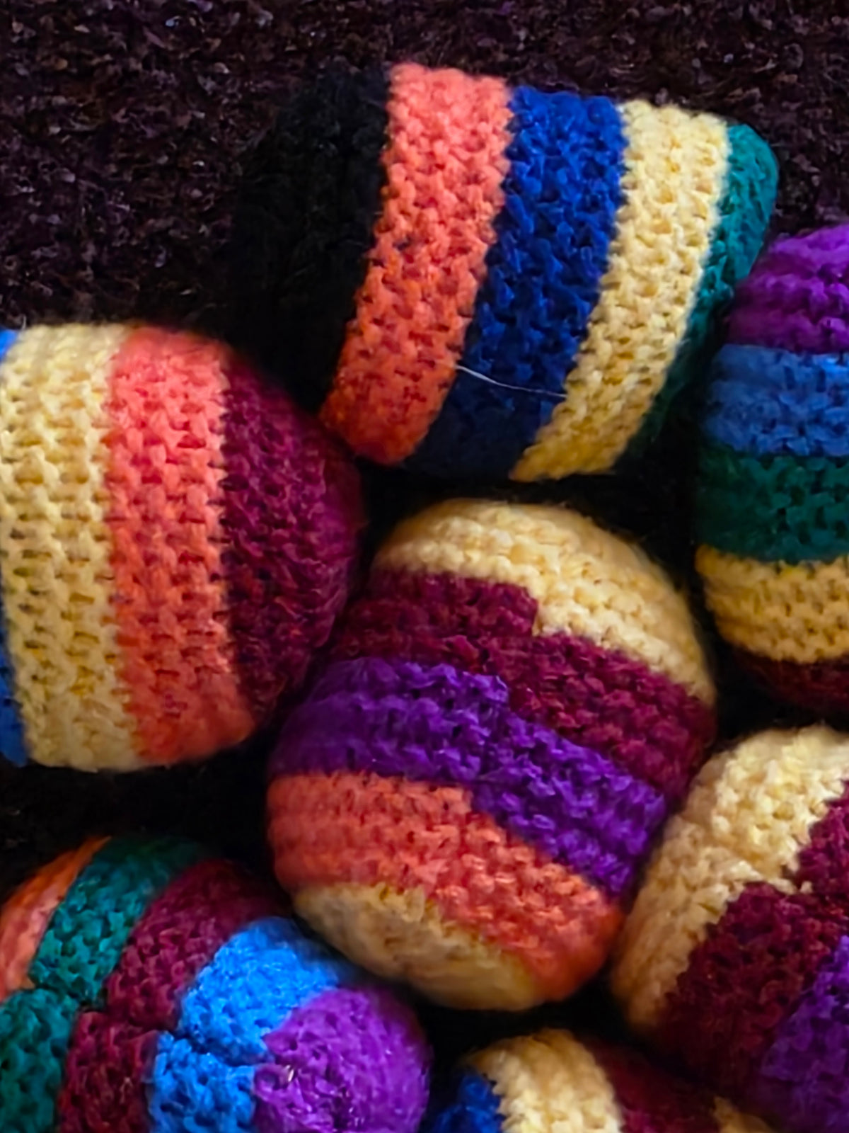 Close-up of striped crocheted hacky sacks